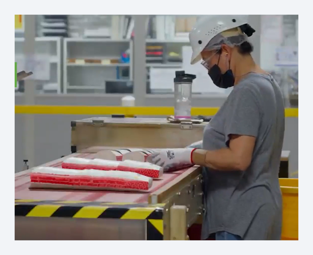 Operator performing quality inspection on packaging components 