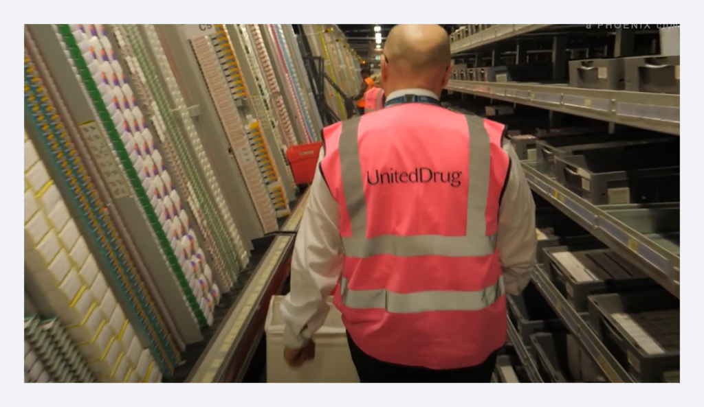 Warehouse operator wearing a United Drug vest